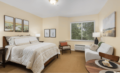 A well-furnished resident room with a cozy atmosphere
