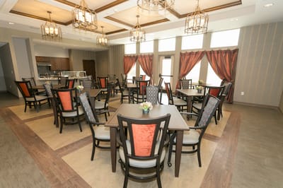 Bright dining room with tables and chairs arranged