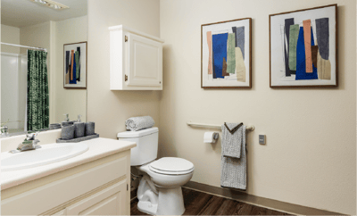 Clean bathroom with artwork and towels