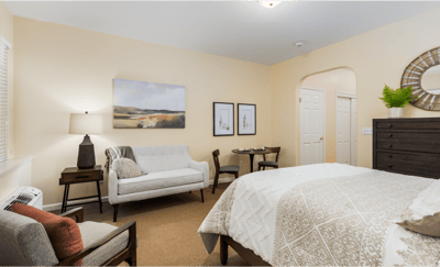 Cozy resident room with a bed and sitting area
