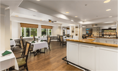 Dining area with neatly set tables and natural light