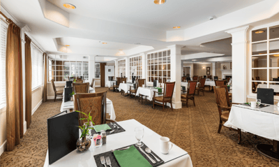 Spacious dining room with neatly set tables