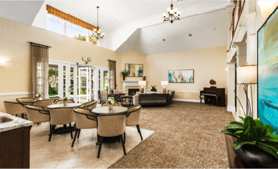 Common area with seating and piano in a bright lounge