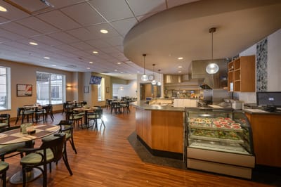 Dining area with tables and a display of food