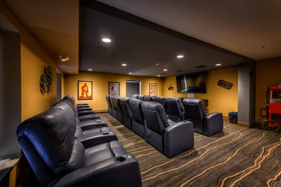 Interior view of a cozy movie theater room with recliners