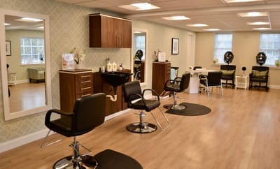 Interior view of a salon area with chairs and mirrors