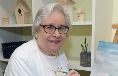 Monroe Village Assisted Living, nursing home in Monroe Township, NJ — Senior resident painting in a recreational activity room