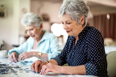 Monroe Village Assisted Living, nursing home in Monroe Township, NJ — Seniors working on a jigsaw puzzle together