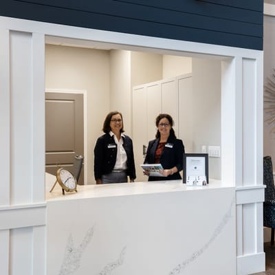 Staff members at the reception desk greeting visitors