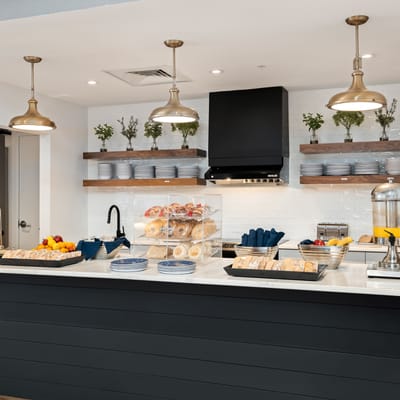 Bright dining area with food display and pastries