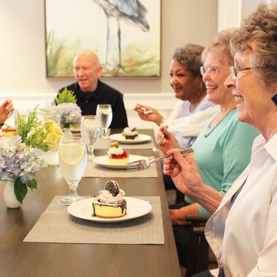 Residents enjoying dessert together in a dining setting
