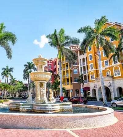 Outdoor fountain in front of colorful building