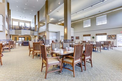 Bright dining area with wooden tables and chairs