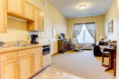 Interior view of a cozy resident room with kitchenette