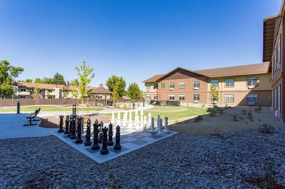 Outdoor area with large chess set and facility building