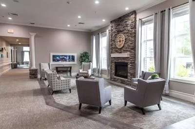 Bright interior common area with seating and fireplace