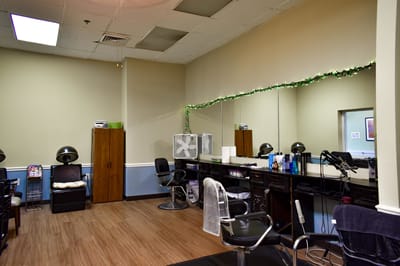 A well-lit hair salon interior with styling chairs and mirrors