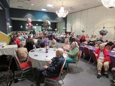 Residents celebrating a birthday in the activity room
