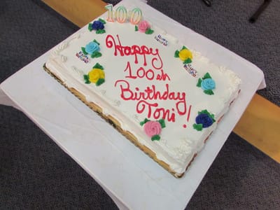 A decorated birthday cake for a 100th birthday celebration