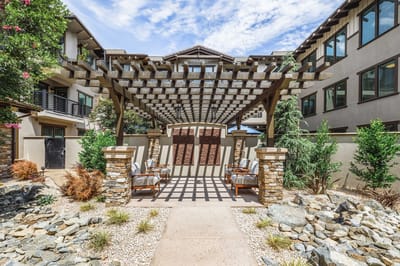 Beautiful outdoor seating area with pergola and landscaping