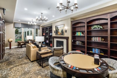 Interior common area with bookshelves and gaming table