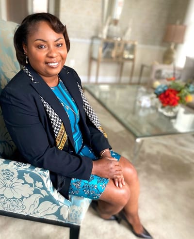 Staff member posing in a well-decorated common area