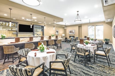 Bright dining room with tables set for residents