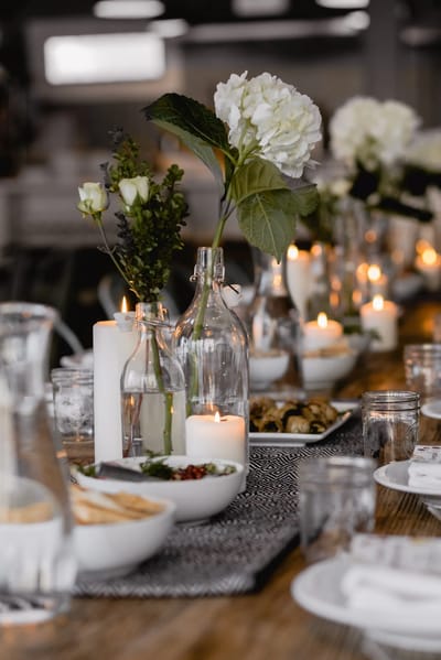 Elegantly set dining table with candles and flowers