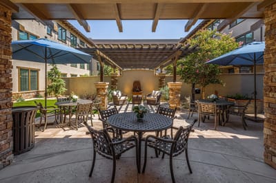 Outdoor patio area with tables and umbrellas