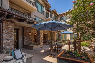 Outdoor seating area with tables and blue umbrellas