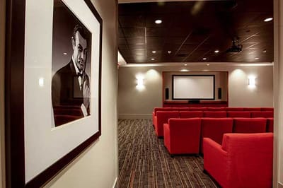 Interior view of a movie theater with red seating