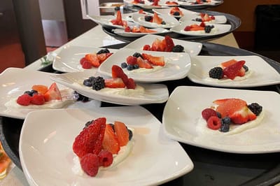 Plates of dessert with fresh berries on display