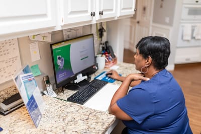 Staff member working on a computer at the front desk