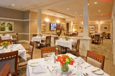 Elegant dining room with tables set for residents