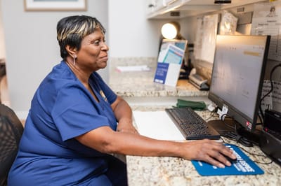 Staff member working at a desk in the facility