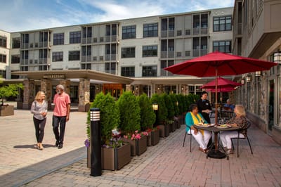 Residents strolling in the outdoor courtyard of the facility
