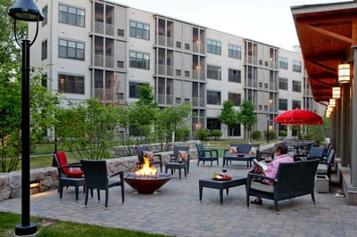 Residents enjoying a fire pit in an outdoor lounge area