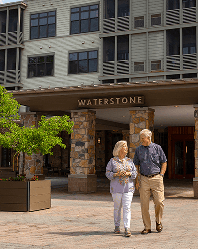 Couple walking in front of Waterstone at Wellesley entrance