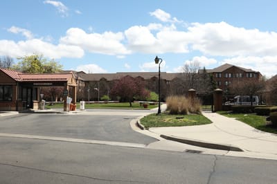 Entrance of Allegria Village with landscaped outdoor space