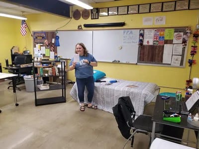 Staff member in a classroom with colorful walls