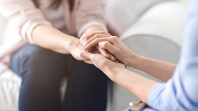 Two hands holding in support.