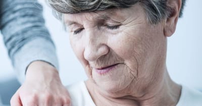 Close-up of a smiling elderly woman with gentle touch