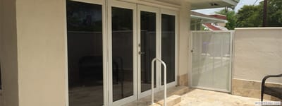 Outdoor space with glass doors and patio area.