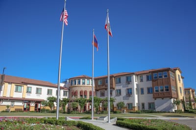 Exterior view of the facility with flags and landscaping