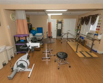 Rehabilitation therapy room with equipment and furniture
