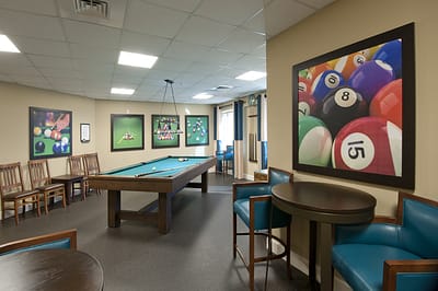 Interior recreation room with a pool table and seating