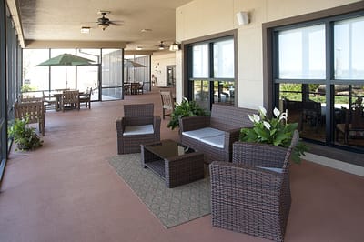 Outdoor seating area with plants in a senior living facility