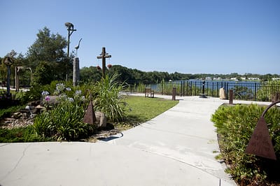 Pathway leading to a serene lakeside garden