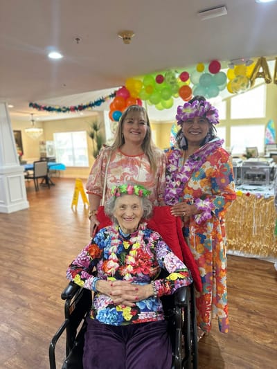 Residents and staff celebrating in a decorated common area
