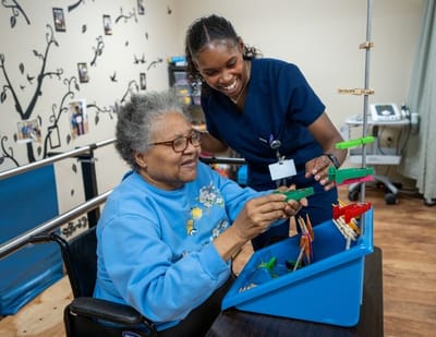 Resident and staff engaging in a therapeutic activity
